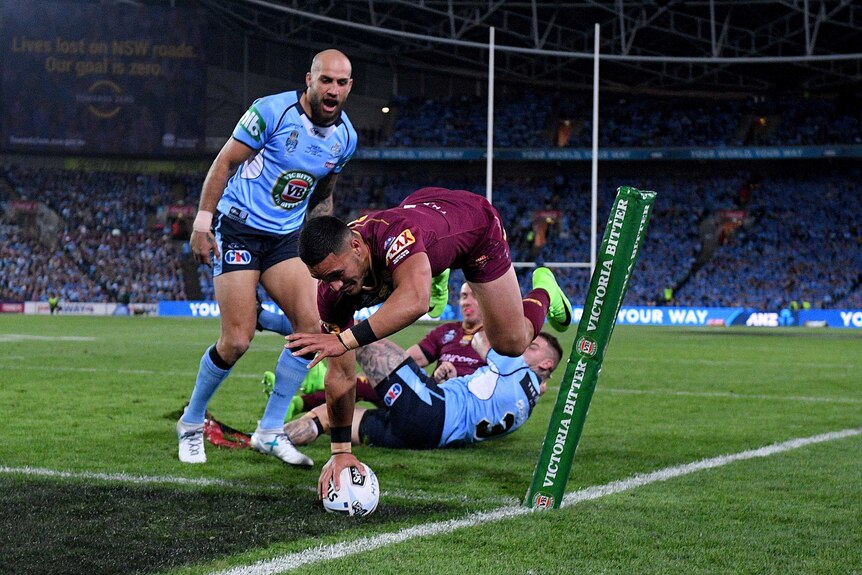 Valentine Holmes of the Maroons scores a try.