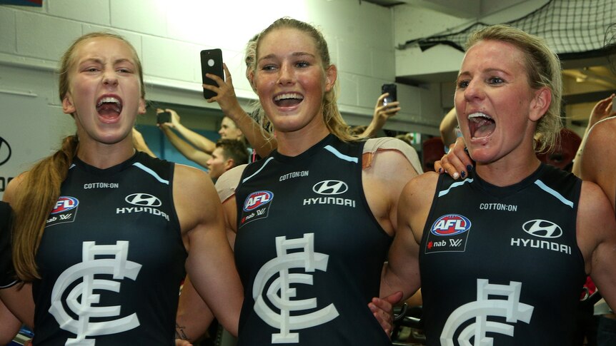 Tayla Harris celebrates alongside teammates in the Carlton sheds after reaching the AFLW grand final