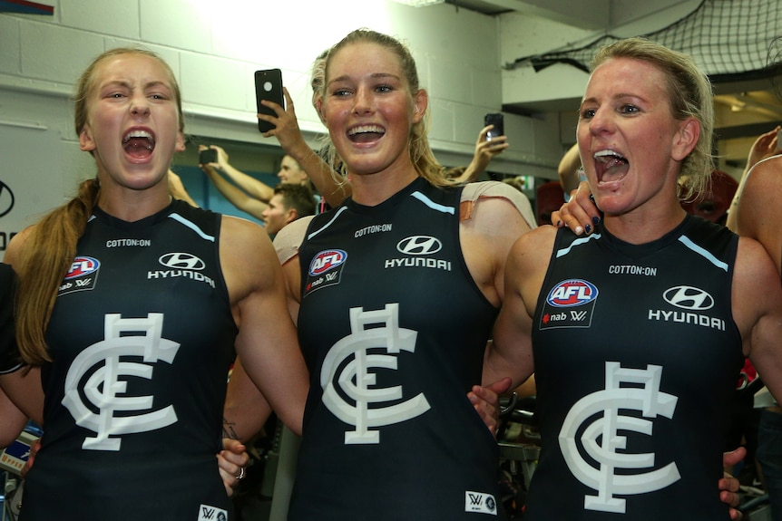 Tayla Harris celebrates alongside teammates in the Carlton sheds after reaching the AFLW grand final