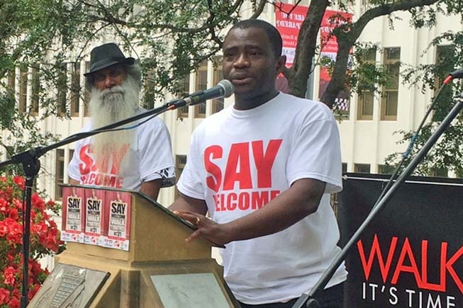 Sierra Leone man John Kamara addresses a rally in Hobart