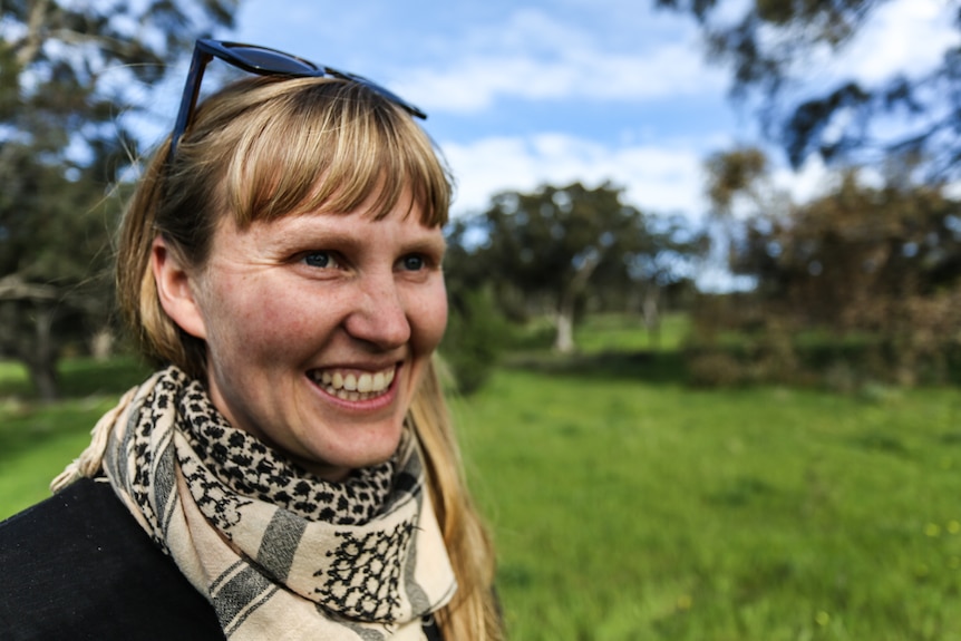 Tess Sellars looks over the land she'll be starting her dairy on.