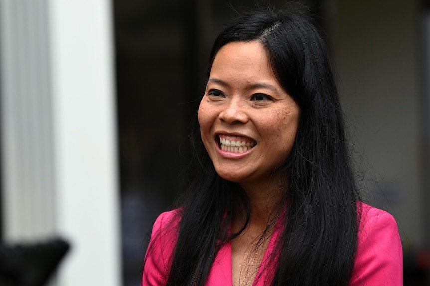 A woman with black hair smiling