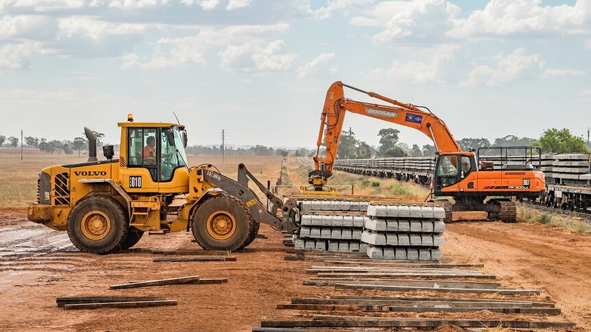 Heavy machinery moving sleepers along the inland rail route.