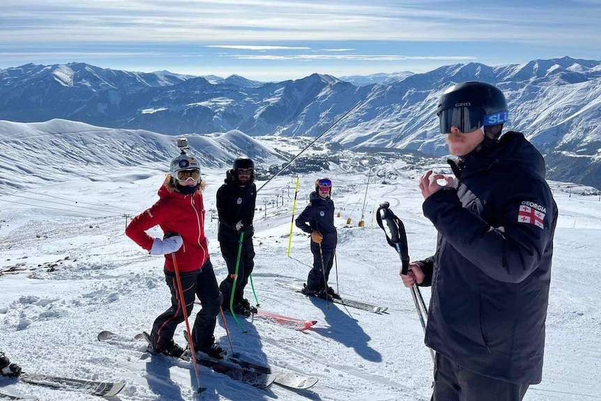 Four skiers on a snowy mountain