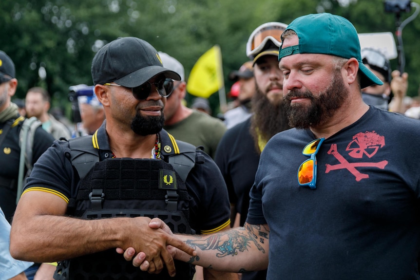 Two members of the Proud Boys shake hands in this file photo from Portland, 2019.