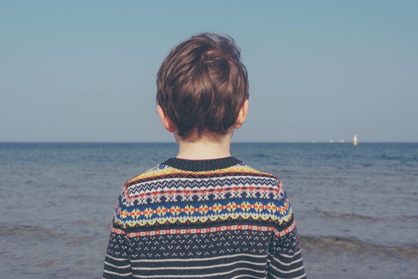 Child staring out to sea
