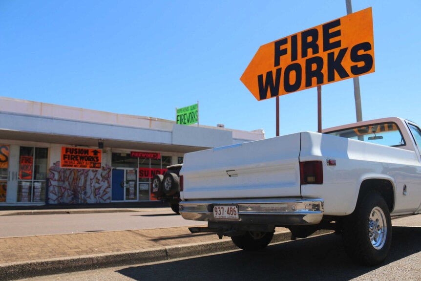 A ute with a sign pointing towards fireworks for sale.