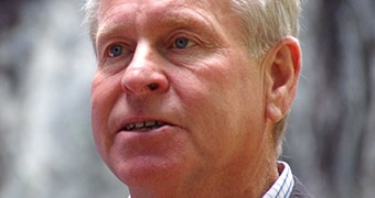 A headshot of Colin Barnett with a grey background