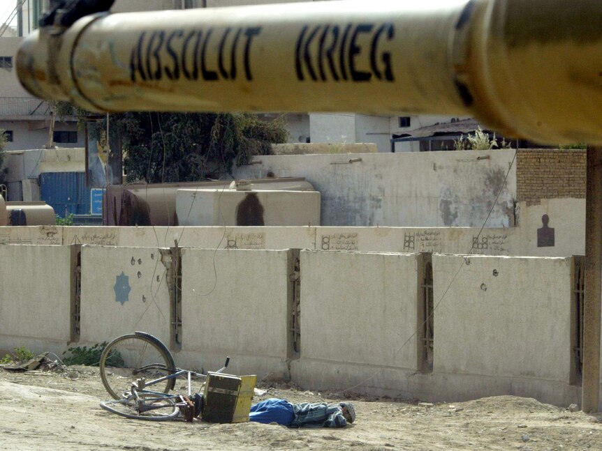 Photograph of the body of a young boy in Iraq in 2003 who was killed as he was riding his bicycle in Karbala.