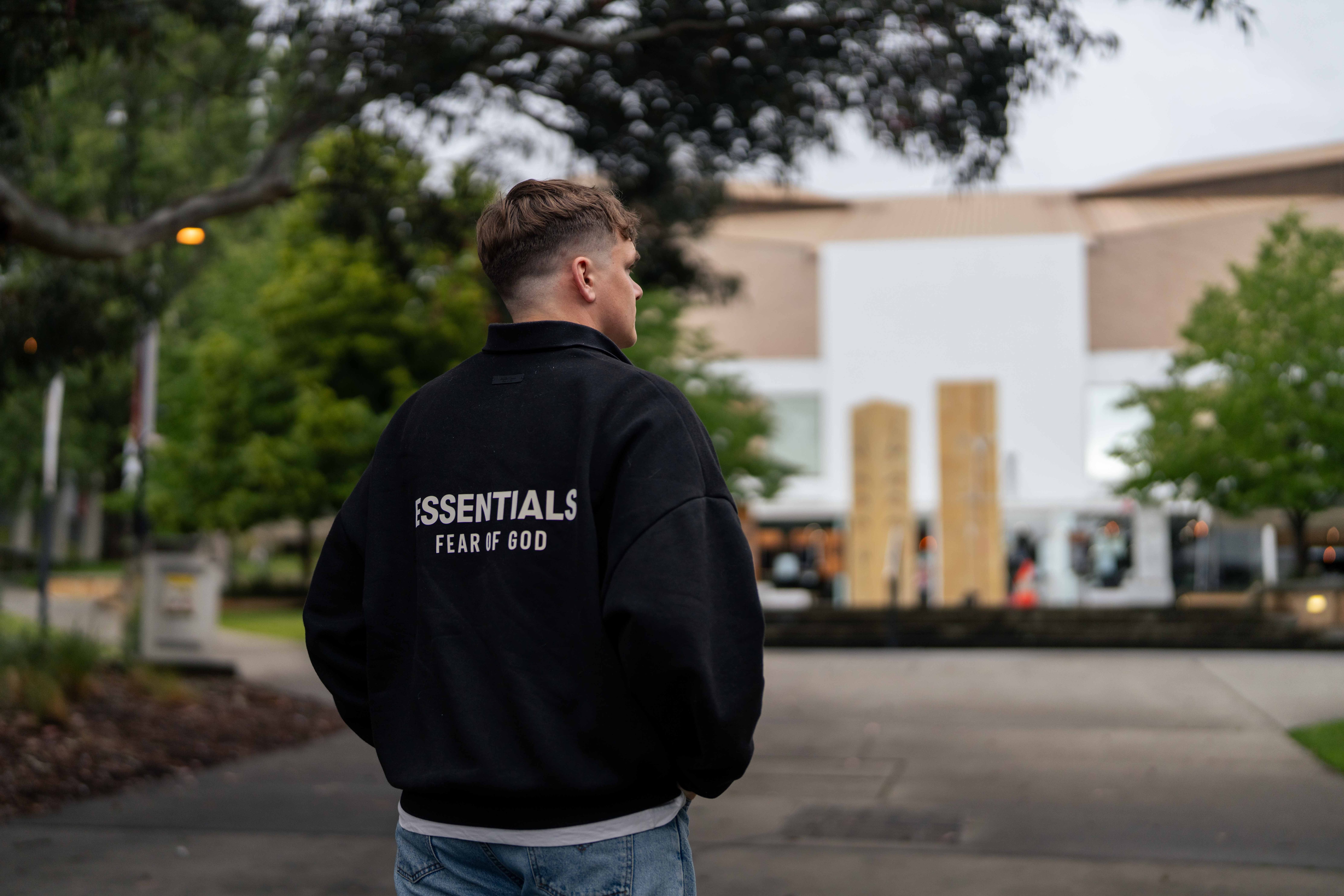 Man stands looking out to a university campus
