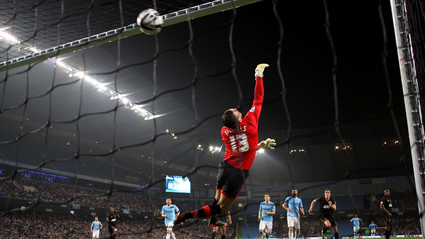 Wigan keeper Lee Nicholls cannot stop Yaya Toure's free kick for Manchester City.