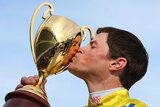 Lapping it up ... Dunaden jockey Craig Williams celebrates with the cup.