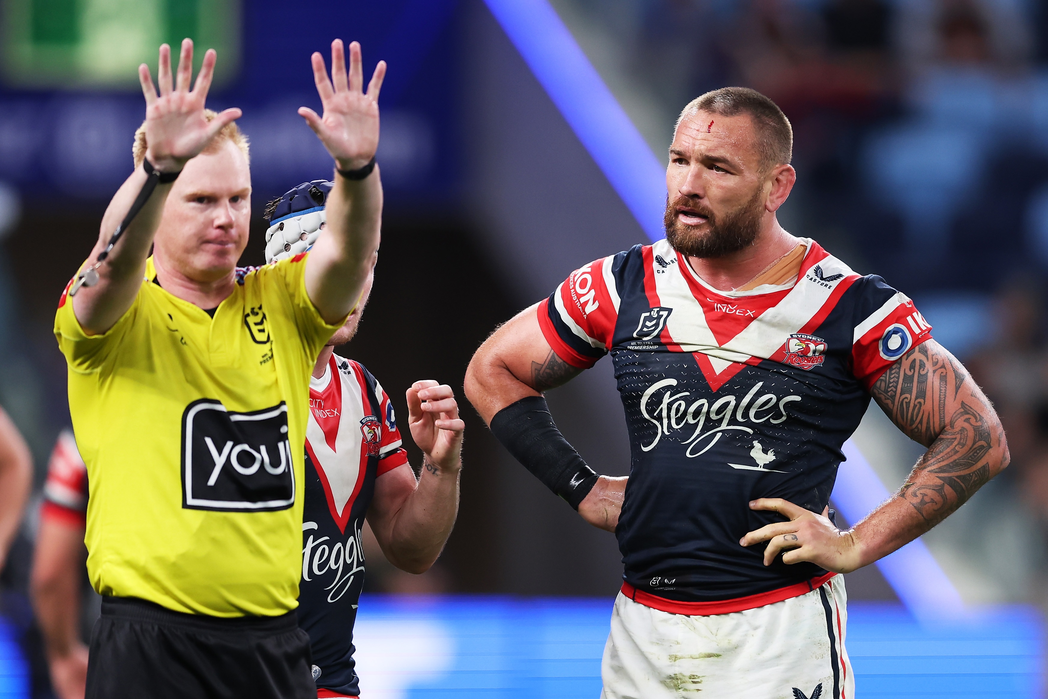 An NRL referee holds two hands up as he sends a Sydney Roosters player to the sin-bin.