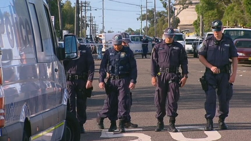 Police search a street in Greenacre after a man was shot in the face and shoulder