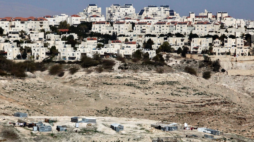 The Israeli settlement of Maaleh Adumim looms over Arab Bedouin shacks in the West Bank.