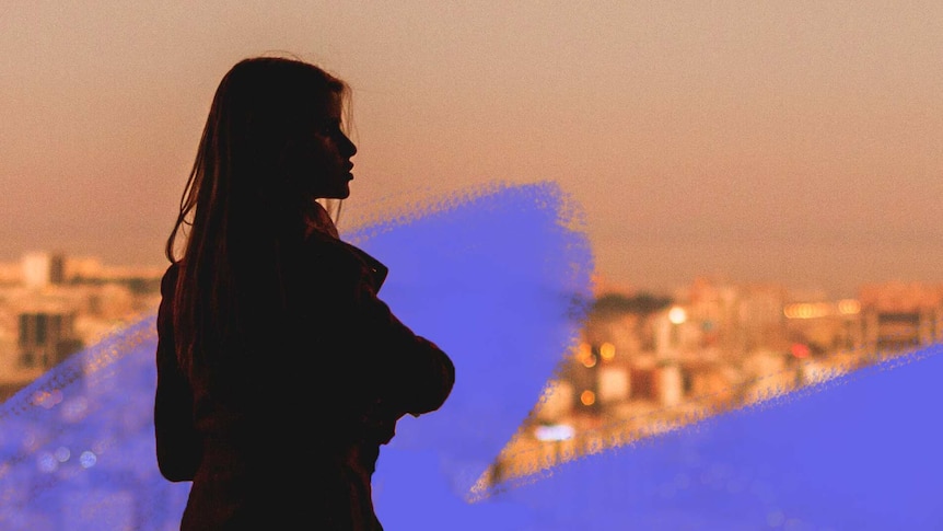 Woman in silhouette looking over city