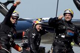 Oracle Team USA celebrates after they beat Emirates Team New Zealand in race 18.