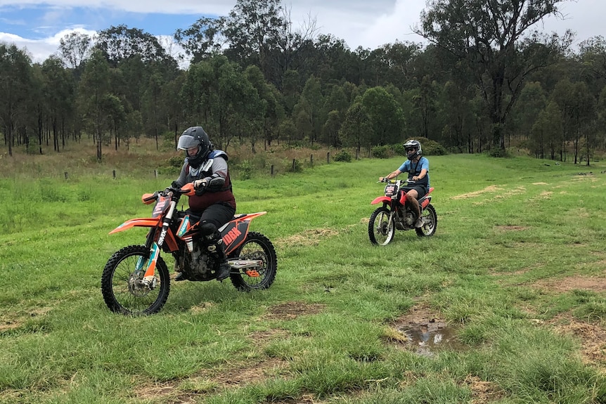 Jack and Chass are pictured riding in the grass with helmets on.