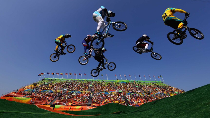 Six BMX competitors soar through the air in a jump during the Cycling BMX - Men's Quarter finals in Rio.