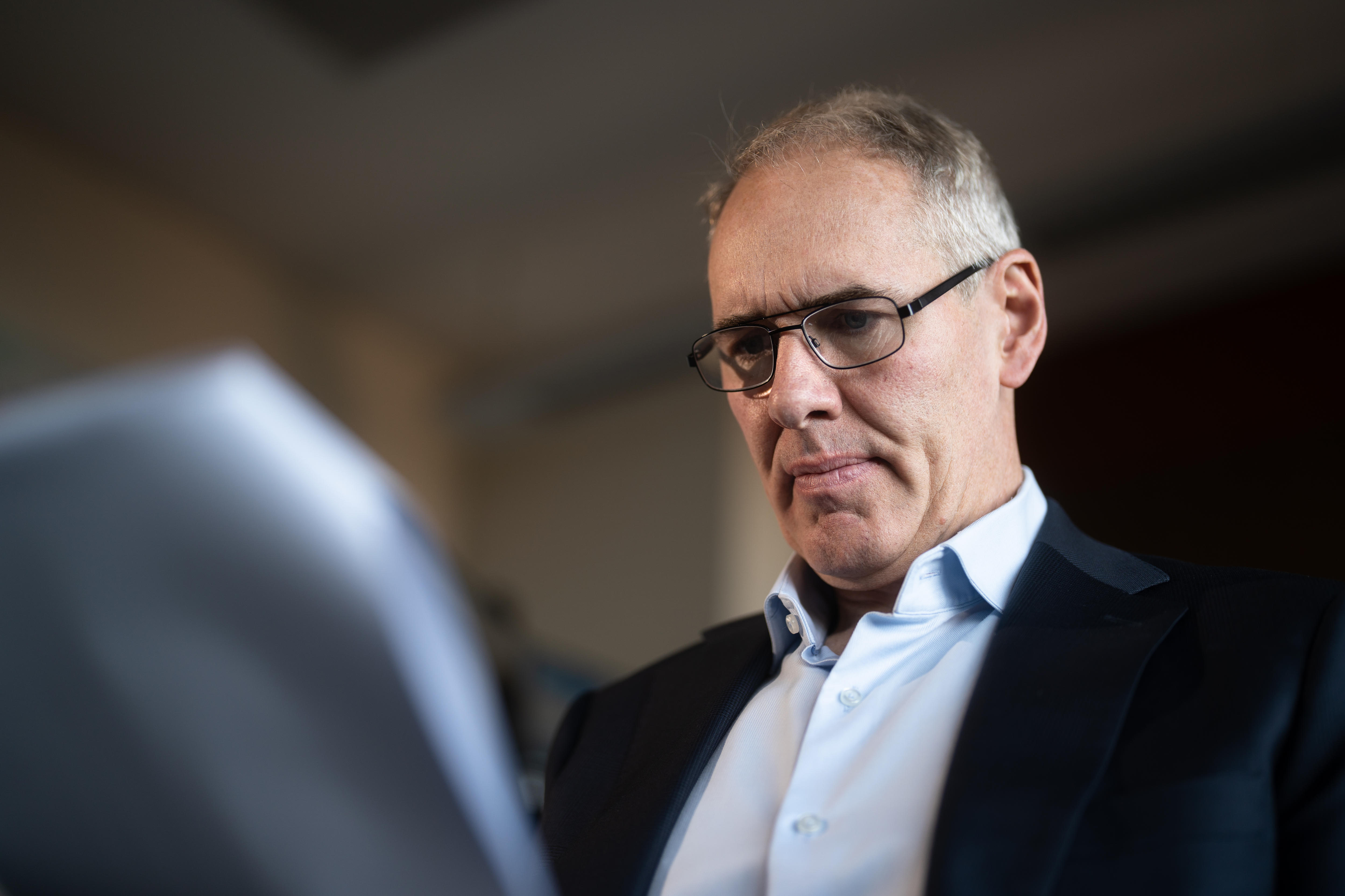 Victor Chang Cardiac Research Centre Director Professor Jason Kovacic sitting inside, reading a printed report
