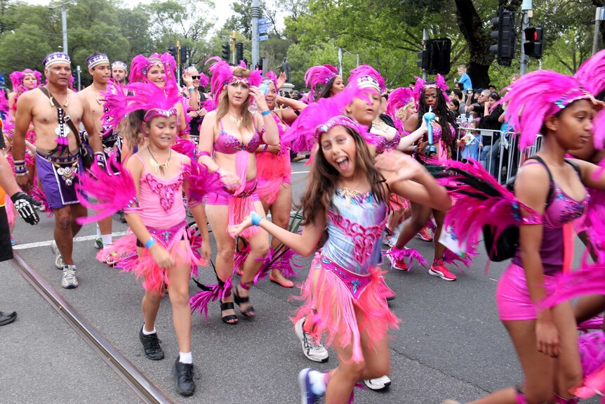 A young girl dances in costume at the Moomba parade