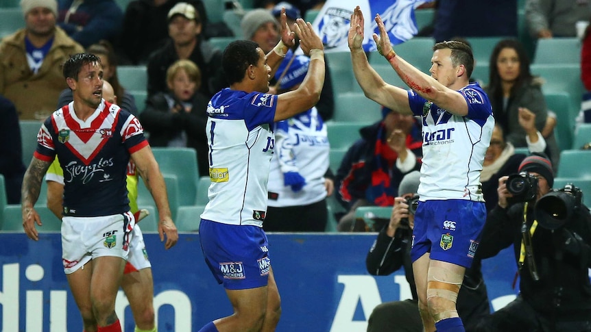 The Bulldogs' Brett Morris (R) celebrates a try against the Roosters on June 30, 2016.
