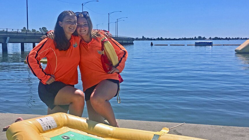 Grace Creenaune (left) and Erica Montgomery, 15 arm in arm at the edge of Lake Mulwala.
