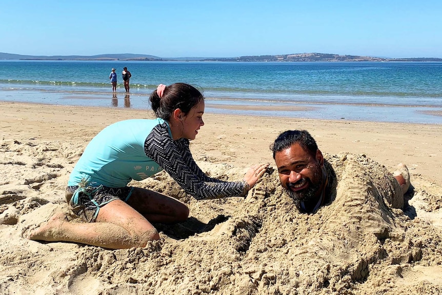 Isi Taufa and Tahlia Martinez having some sandy fun at Kingston Beach.