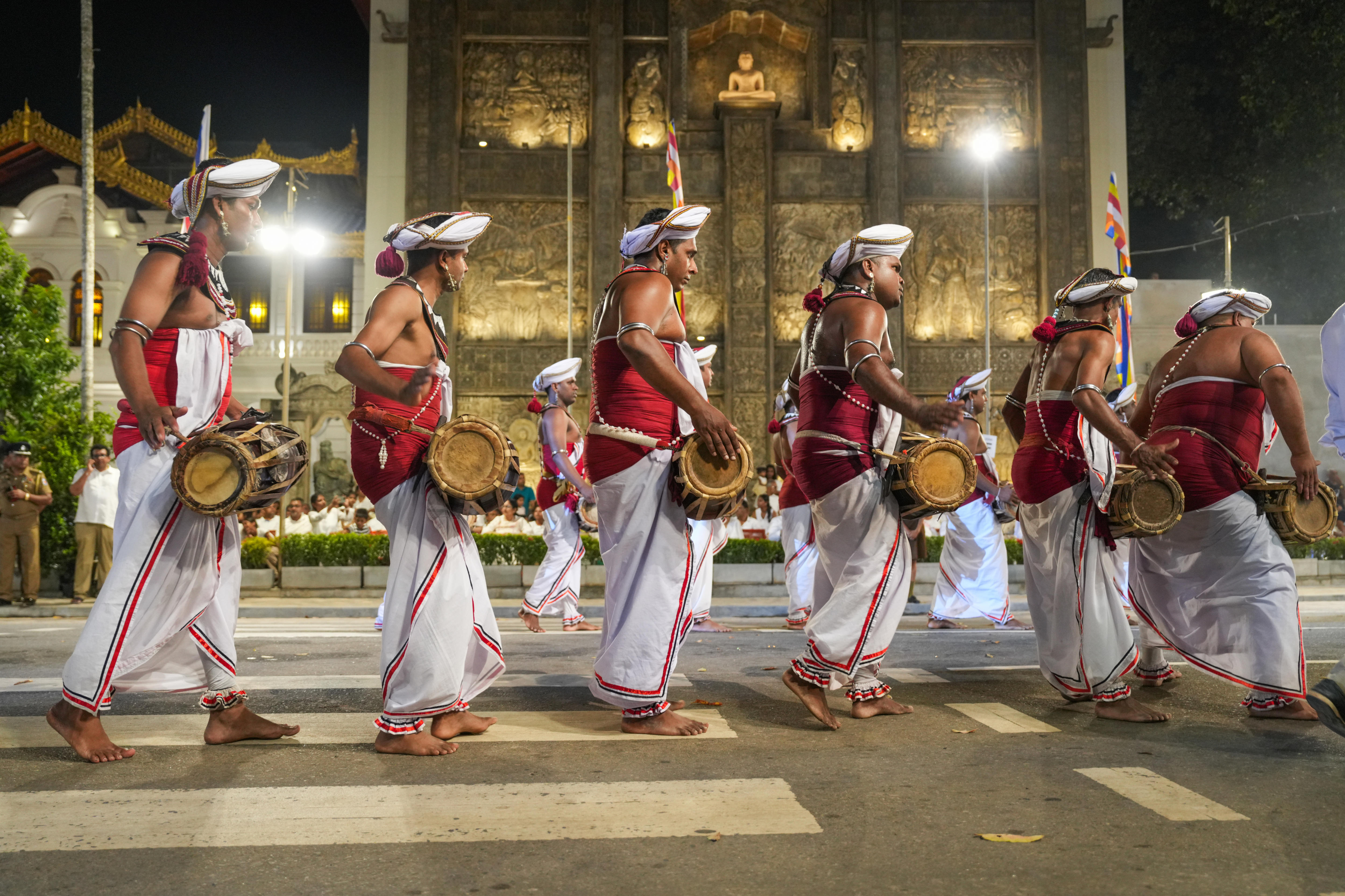 A procession of Buddhist devotees in a Sri Lankan temple