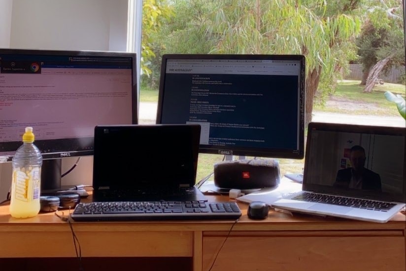 two laptops and two dual screens on a desk