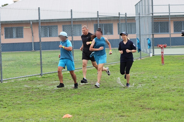 Officers running beside inmates at Brisbane Women's Correctional Centre