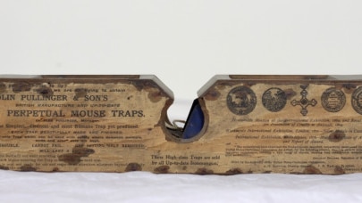 A wooden box-type mouse trap.
