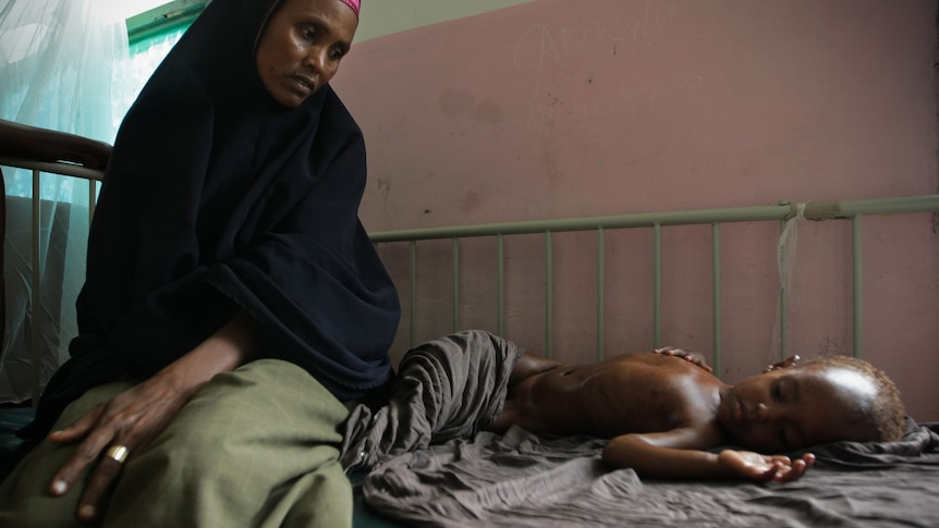 A Somali mother looks at her malnourished and dehydrated child [AFP/AU-UN IST: Stuart Price]