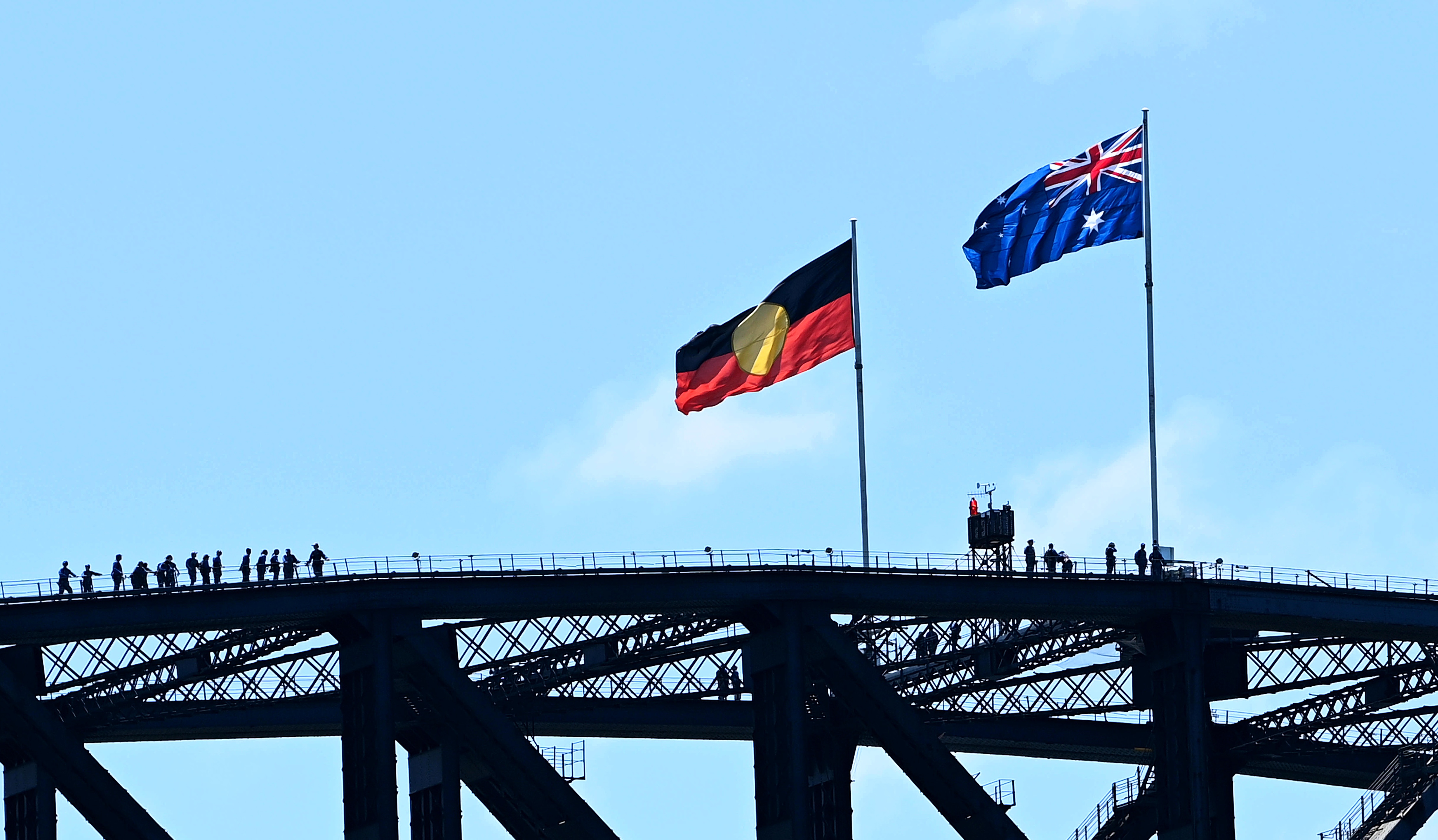 The Aboriginal flag and the Australian flag atop the Sydney Harbour Bridge