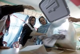 Women count ballot papers after the close of polling stations