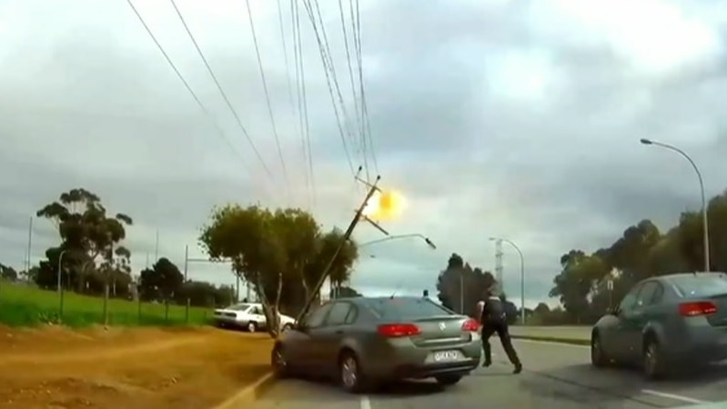 Police dashcam footage of car bringing down power lines