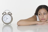 Young woman looking at a clock