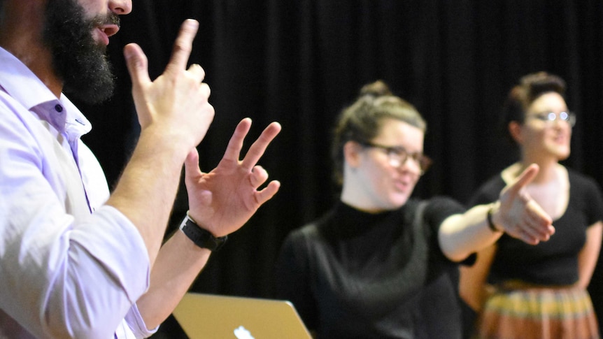 Jessica and Ilana from Deafferent Theatre work with a sign language interpreter at a workshop.