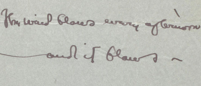 Closeup of a letter that reads, 'The wind blows every afternoon'.