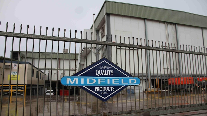 A factory with the fence and gates locked