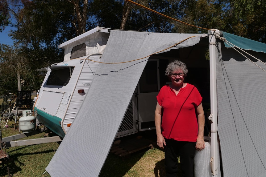 Evelyn in front of a white caravan 