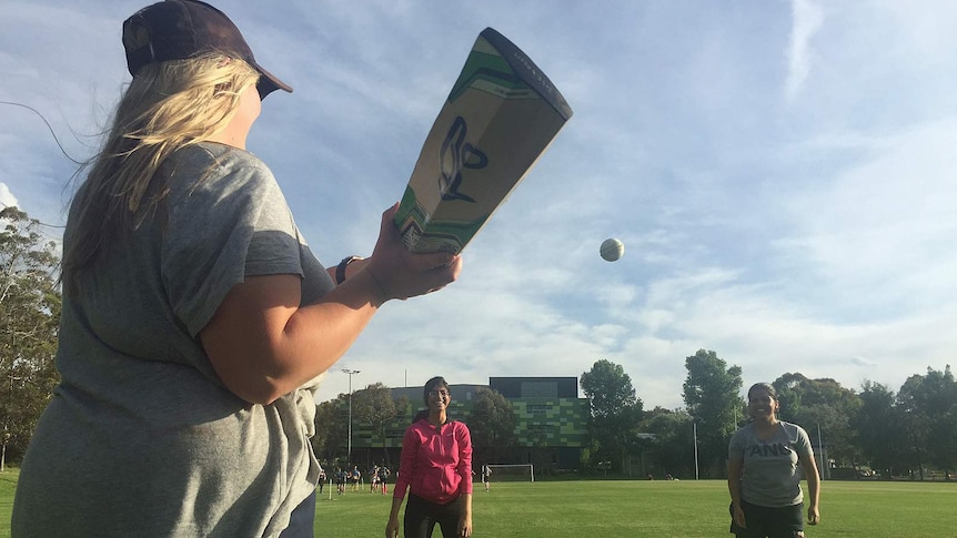 Mary Waters plays cricket with ANU teammates