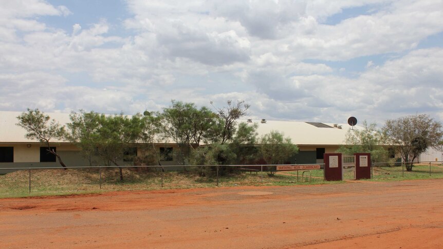 The Yuendumu Regional Health Clinic is on the side of a dusty red road.