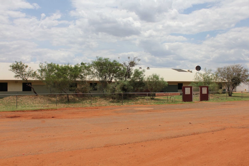 The Yuendumu Regional Health Clinic is on the side of a dusty red road.