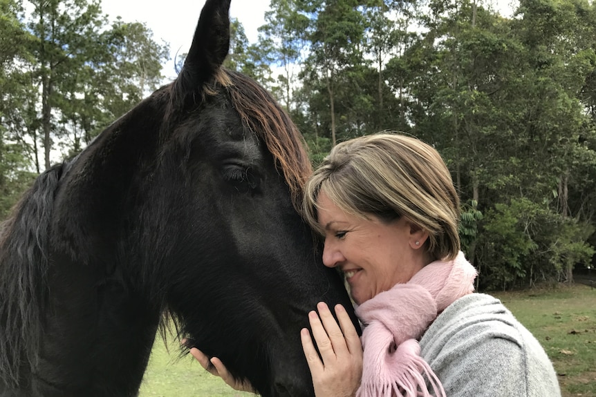 Theresa Hanich smiling down at Reijker as she holds his nose.