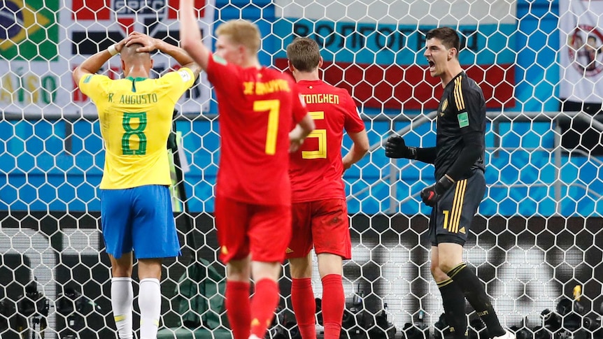 Thibaut Courtois celebrates a save for Belgium against Brazil