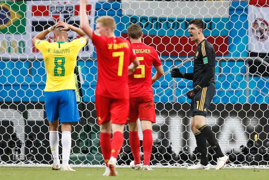 Thibaut Courtois celebrates a save for Belgium against Brazil