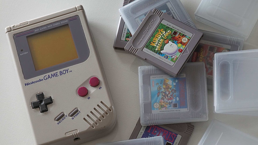 A 1989 Nintendo Game Boy and game cartridges in their plastic boxes.