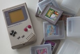 A 1989 Nintendo Game Boy and game cartridges in their plastic boxes.