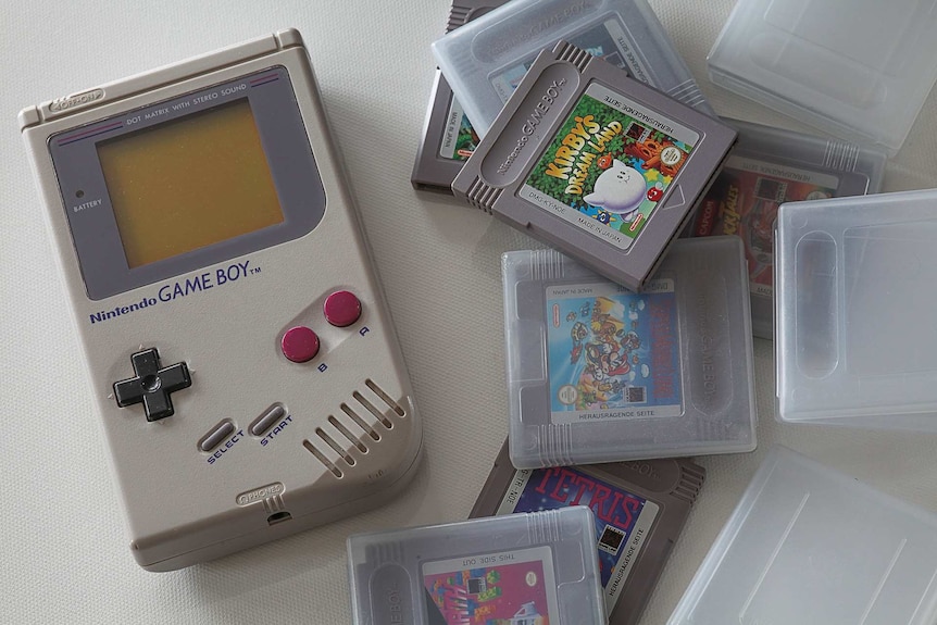 A 1989 Nintendo Game Boy and game cartridges in their plastic boxes.